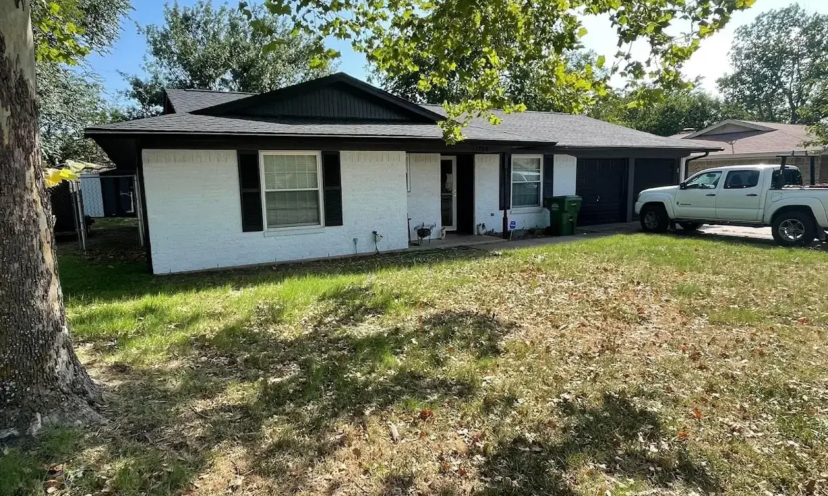 Professional roofing crew working on a residential roof in Forest
